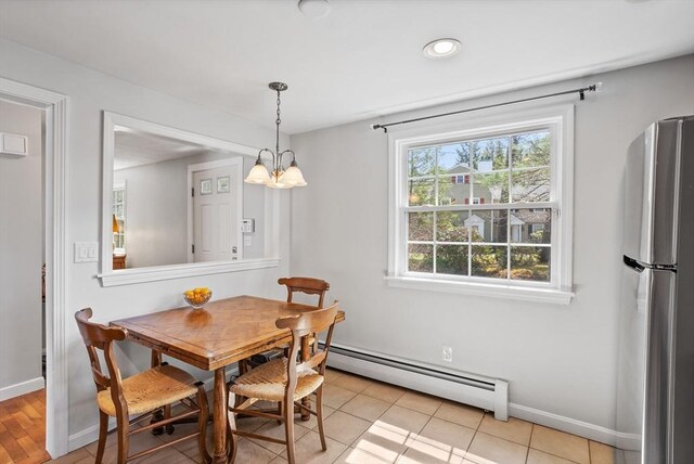 dining room with baseboards, a baseboard radiator, and a notable chandelier