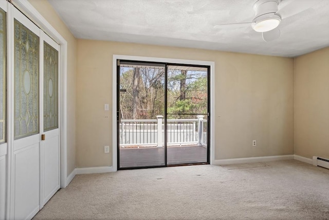 empty room featuring carpet floors, baseboards, and ceiling fan