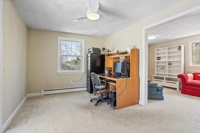 office area featuring carpet flooring, a ceiling fan, a baseboard heating unit, and plenty of natural light