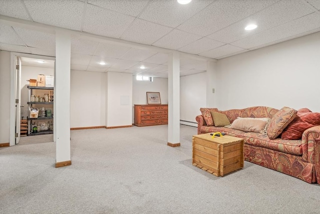 carpeted living room featuring baseboards, baseboard heating, a drop ceiling, and recessed lighting