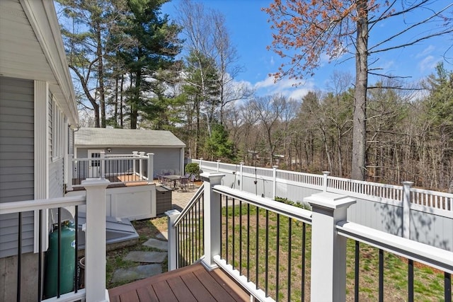 wooden terrace with a fenced backyard
