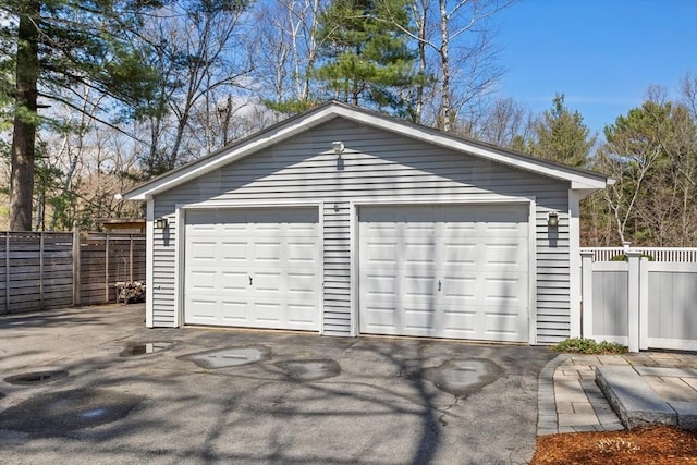 detached garage featuring fence