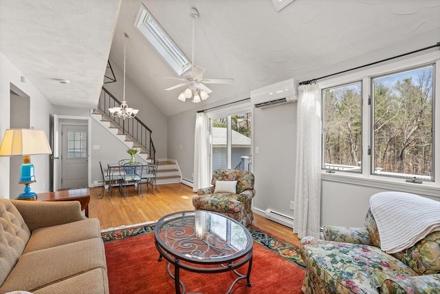 living area featuring a wall mounted air conditioner, wood finished floors, stairway, a baseboard heating unit, and lofted ceiling
