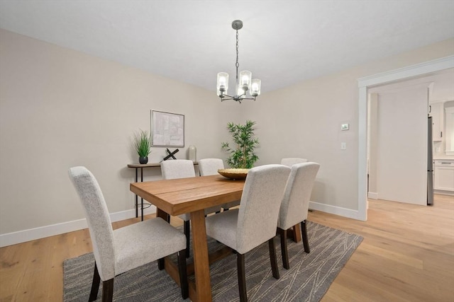 dining area featuring a chandelier and light hardwood / wood-style flooring