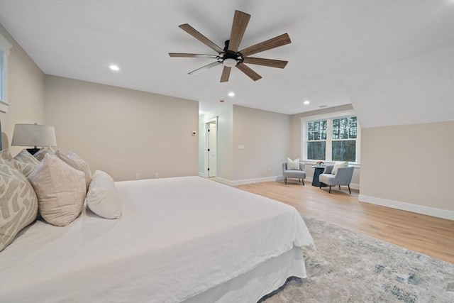 bedroom featuring ceiling fan, vaulted ceiling, and light wood-type flooring