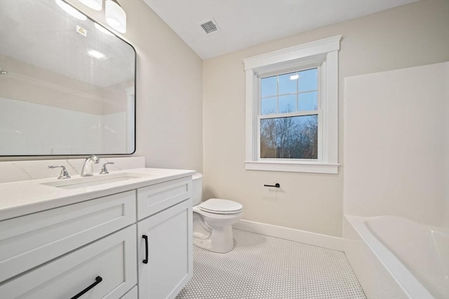 bathroom featuring tile patterned flooring, vanity, and toilet