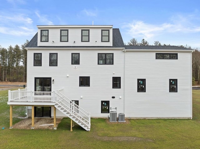 back of house with a yard, central AC, and a deck