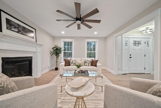 living room featuring ceiling fan and light hardwood / wood-style floors