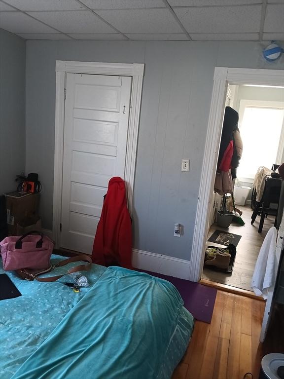 248 S Main St, Attleboro, MA 02703 - bedroom featuring wood finished floors, a paneled ceiling, and baseboards