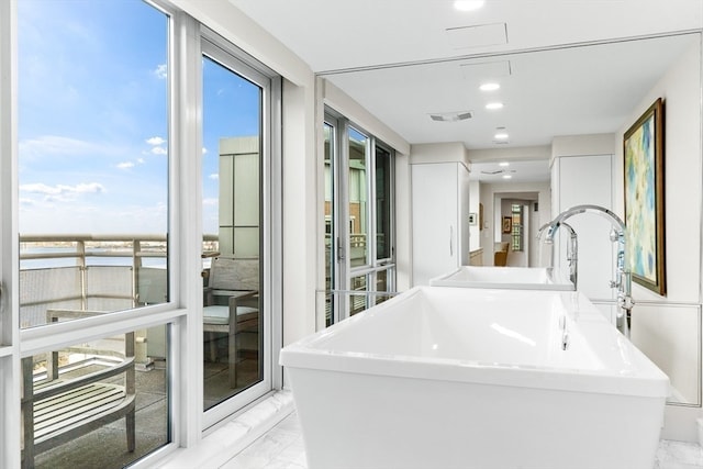 bathroom with a tub to relax in