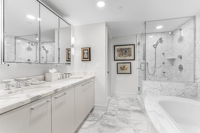 bathroom featuring vanity and independent shower and bath