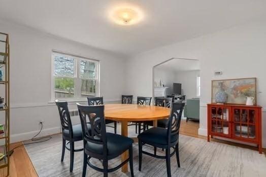 dining room featuring light wood-style flooring and baseboards