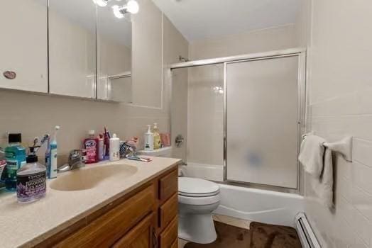 full bathroom with enclosed tub / shower combo, vanity, baseboard heating, and toilet