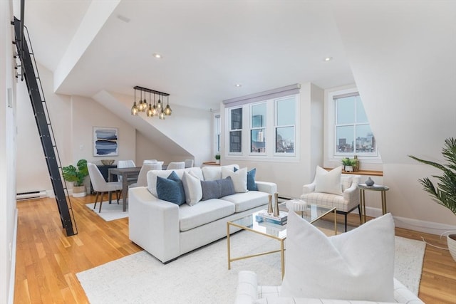 living room featuring light hardwood / wood-style floors and a baseboard heating unit