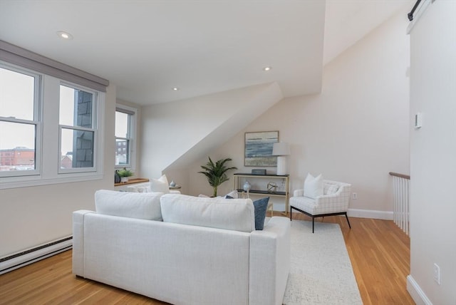 living room with light hardwood / wood-style floors and a baseboard heating unit