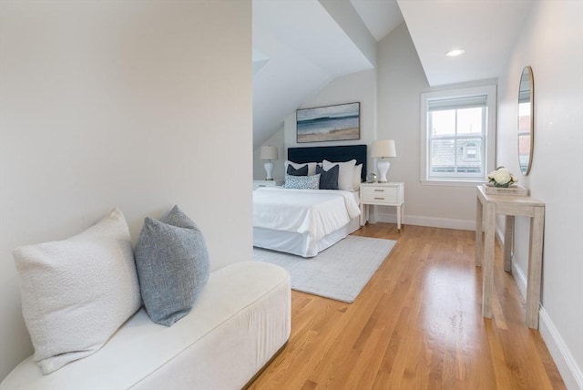 bedroom with hardwood / wood-style flooring and vaulted ceiling