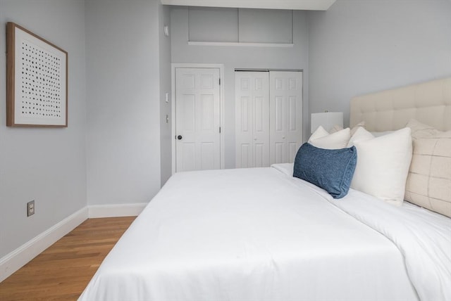 bedroom with a closet and hardwood / wood-style flooring