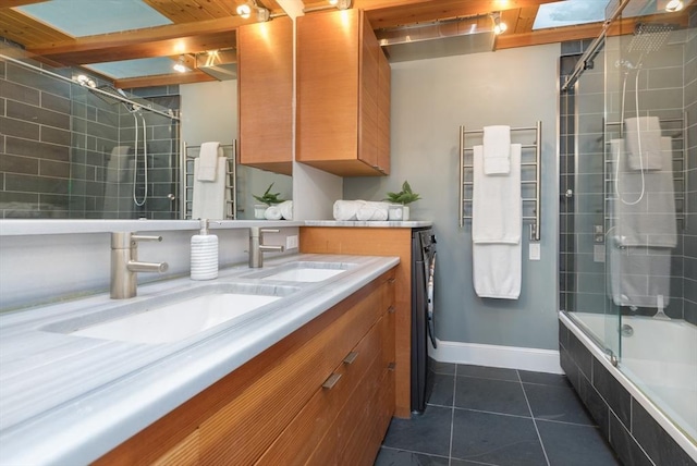 bathroom featuring combined bath / shower with glass door, vanity, and tile patterned floors