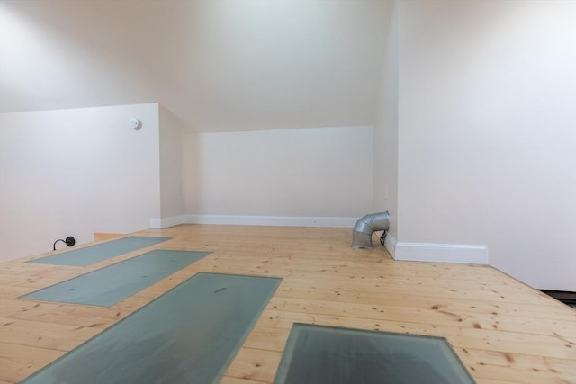 exercise room with vaulted ceiling