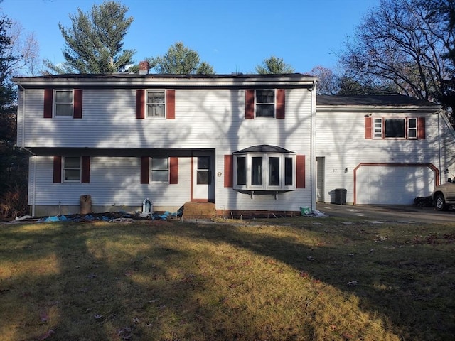 view of front of property featuring a garage and a front yard