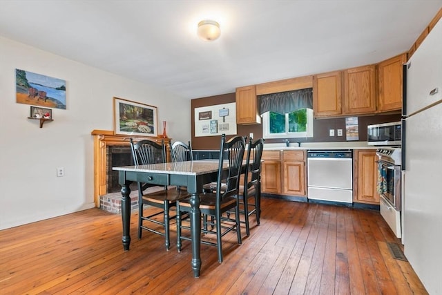 52 Lake Shore Dr, Essex, MA 01929 - kitchen featuring stainless steel appliances, light countertops, dark wood-style flooring, and a sink