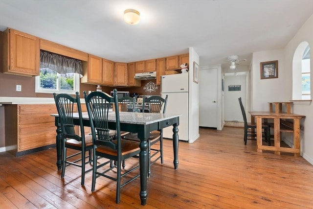 52 Lake Shore Dr, Essex, MA 01929 - dining room featuring light wood-type flooring, baseboards, and arched walkways