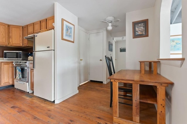 52 Lake Shore Dr, Essex, MA 01929 - kitchen featuring range, freestanding refrigerator, stainless steel microwave, wood-type flooring, and a ceiling fan