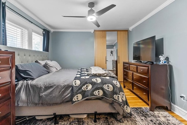 bedroom with a ceiling fan, light wood-type flooring, and crown molding