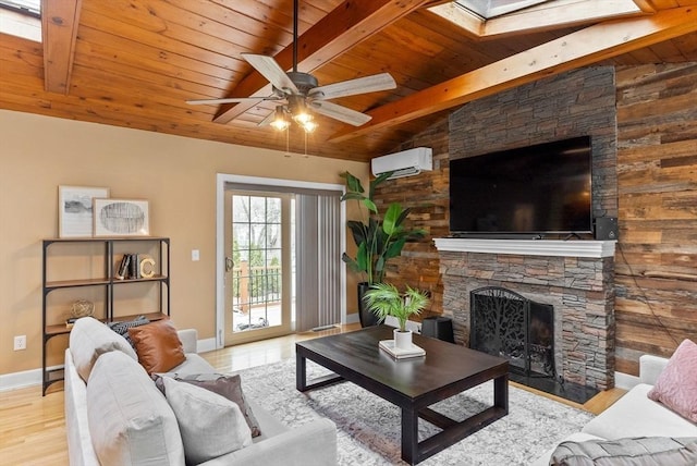 living room with a stone fireplace, a wall mounted AC, wooden ceiling, and wood finished floors