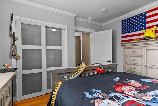 bedroom featuring light wood finished floors and ornamental molding