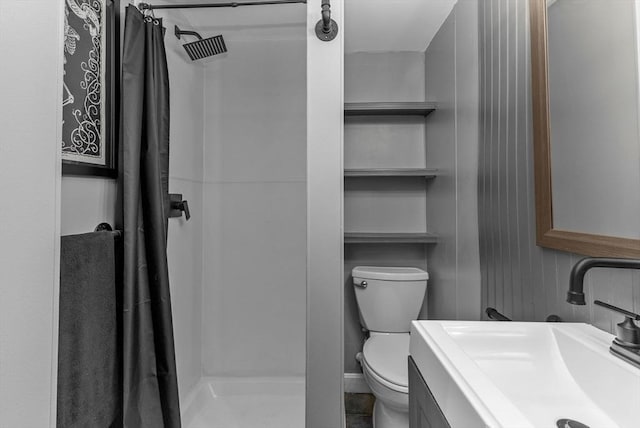 full bathroom with a shower stall, toilet, and vanity