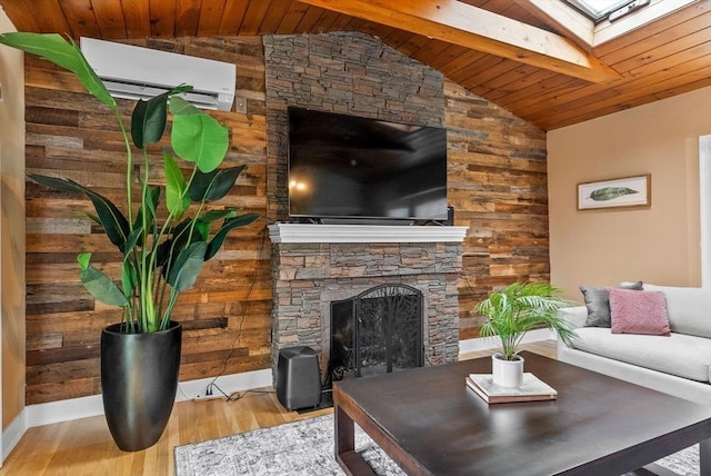 living room featuring a stone fireplace, wood finished floors, wood ceiling, lofted ceiling with skylight, and a wall mounted air conditioner