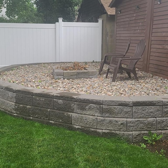 view of yard featuring a fire pit and fence