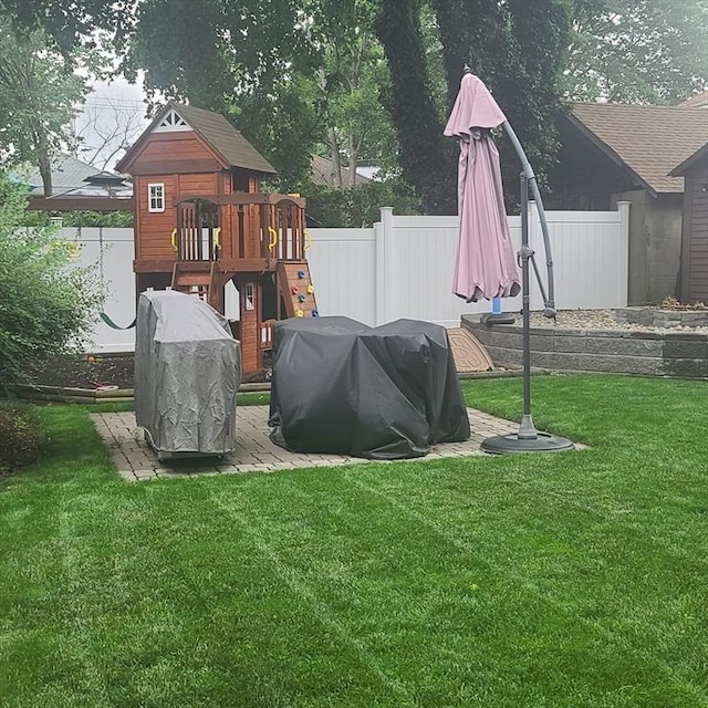 view of play area featuring a yard and fence