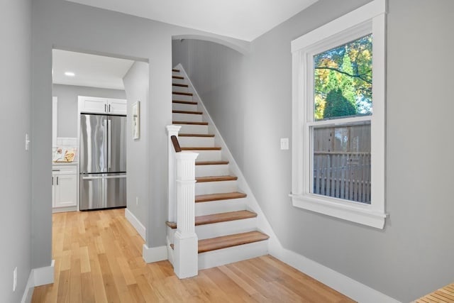 staircase with hardwood / wood-style floors