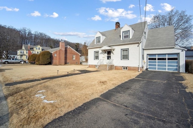 cape cod-style house featuring a garage