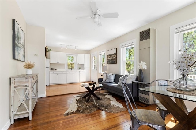 1 Batchelder Ave, North Reading, MA 01864 - living room featuring dark wood finished floors, plenty of natural light, ceiling fan, and a heating unit