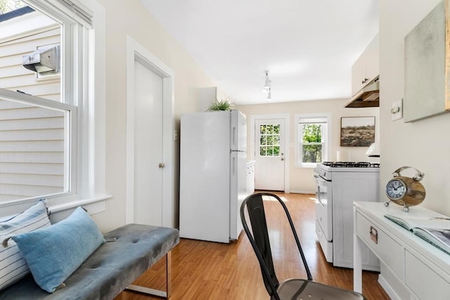 1 Batchelder Ave, North Reading, MA 01864 - kitchen featuring white appliances, under cabinet range hood, light wood-style floors, and white cabinets