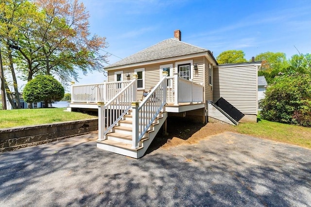 1 Batchelder Ave, North Reading, MA 01864 - back of house featuring a chimney, a deck, and roof with shingles