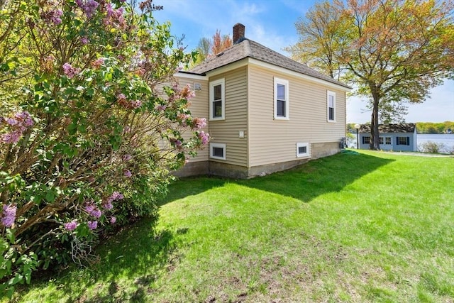 1 Batchelder Ave, North Reading, MA 01864 - view of home's exterior featuring a chimney and a yard