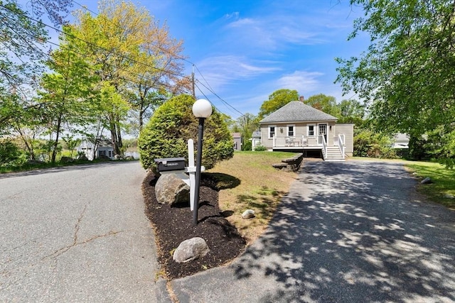 1 Batchelder Ave, North Reading, MA 01864 - view of front of house with driveway and a wooden deck
