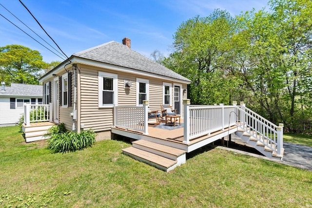1 Batchelder Ave, North Reading, MA 01864 - back of property featuring a chimney, a lawn, a wooden deck, and roof with shingles
