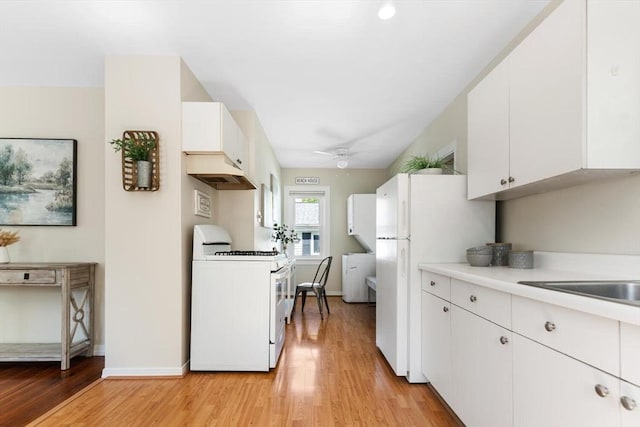 1 Batchelder Ave, North Reading, MA 01864 - kitchen with white appliances, ventilation hood, light countertops, light wood-style floors, and ceiling fan