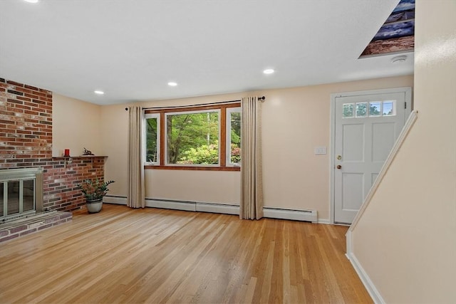81 Baldwin Rd, Billerica, MA 01821 - living area with wood finished floors, a skylight, a baseboard radiator, and recessed lighting