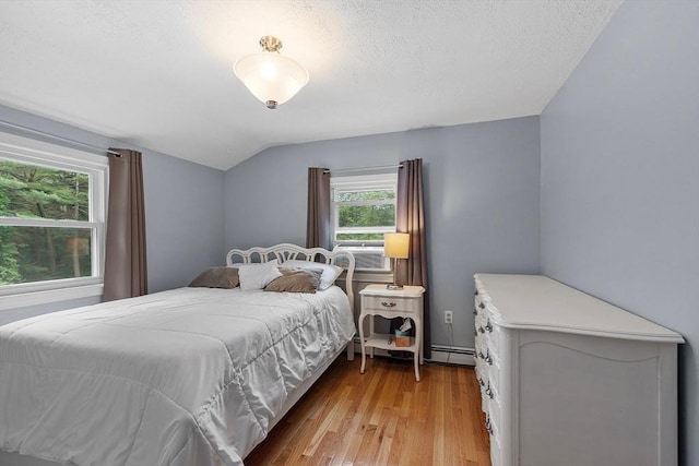 81 Baldwin Rd, Billerica, MA 01821 - bedroom with lofted ceiling, light wood-style floors, baseboard heating, and cooling unit