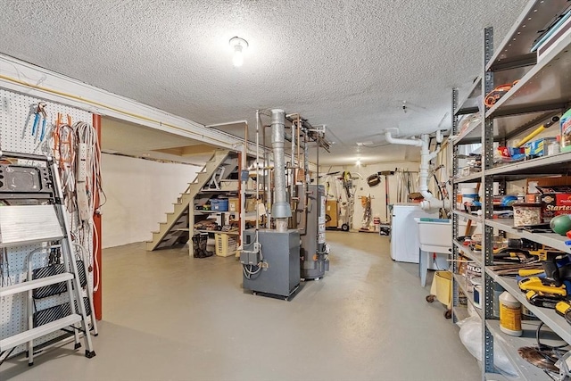 81 Baldwin Rd, Billerica, MA 01821 - finished below grade area with washer / dryer, a textured ceiling, stairs, and water heater