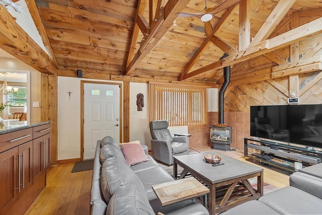81 Baldwin Rd, Billerica, MA 01821 - living room with wooden ceiling, a wood stove, light wood-type flooring, a chandelier, and wood walls
