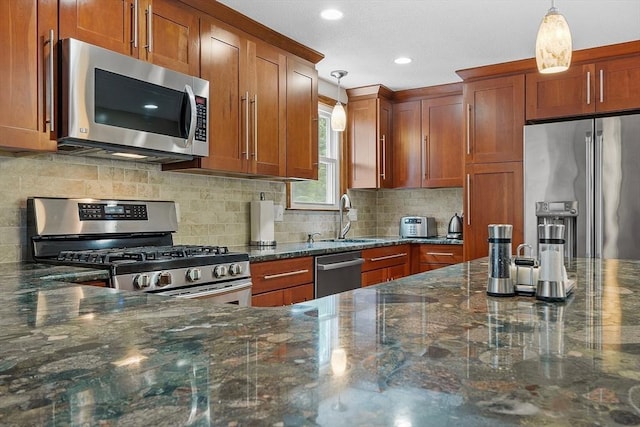 81 Baldwin Rd, Billerica, MA 01821 - kitchen featuring appliances with stainless steel finishes, brown cabinetry, pendant lighting, and recessed lighting