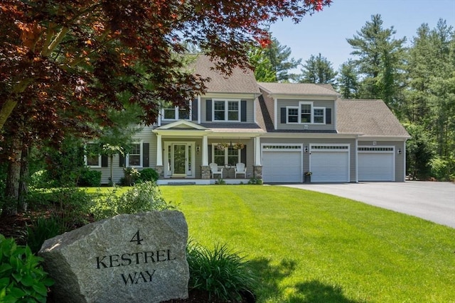 4 Kestrel Way, Carver, MA 02330 - view of front facade featuring a front yard, asphalt driveway, and covered porch