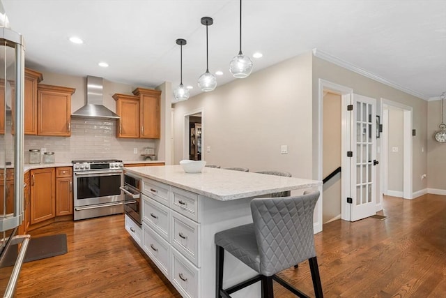 4 Kestrel Way, Carver, MA 02330 - kitchen featuring wall chimney range hood, appliances with stainless steel finishes, a kitchen island, decorative backsplash, and ornamental molding